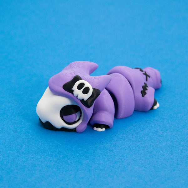 Kawaii Goth Reapo the Reaper Chonk in a lilac hood with a skull bow, front three-quarter view