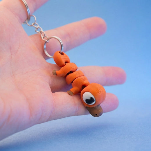 Orange platypus keyring version hanging from a keyring chain