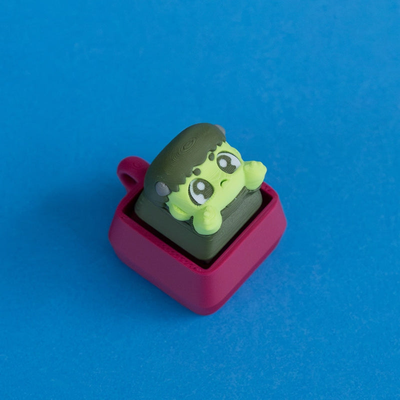 Boltsy the frankenstein keycap on plum clicker base three quarter view.