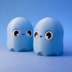 Two powder-blue ghost bean fidgets shown side by side