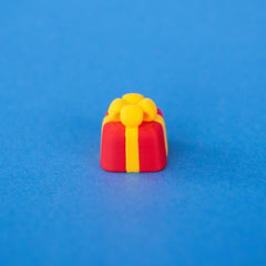 Bowsy the red present Christmas keycap, angled view