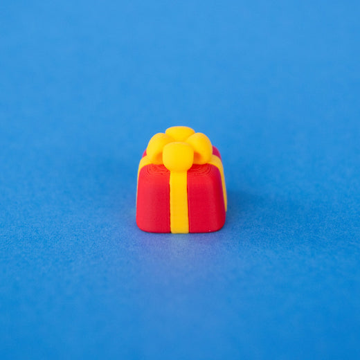 Bowsy the red present Christmas keycap, angled view