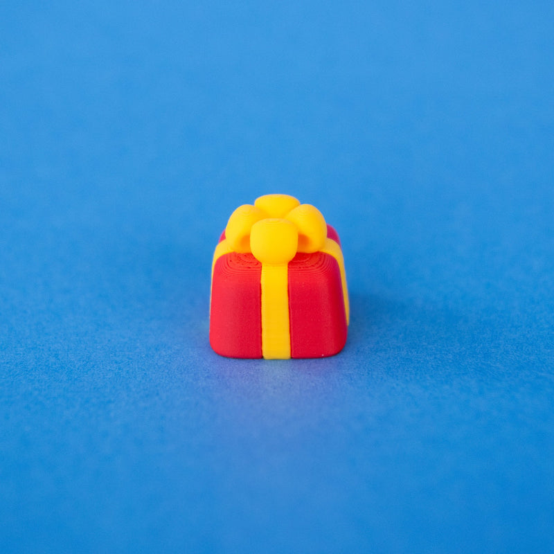Bowsy the red present Christmas keycap, angled view