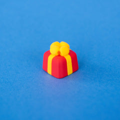 Bowsy the red present keycap with a yellow bow