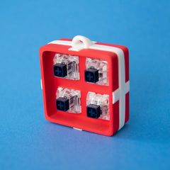 Red four-slot gift box base with switches, front view