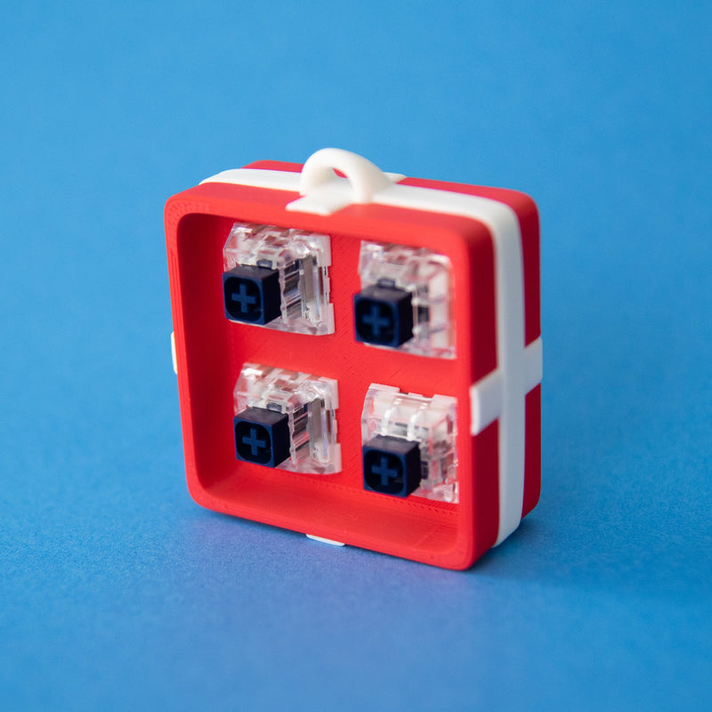 Red four-slot gift box base with switches, front view