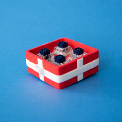 Red four-slot gift box base with switches, seen from above