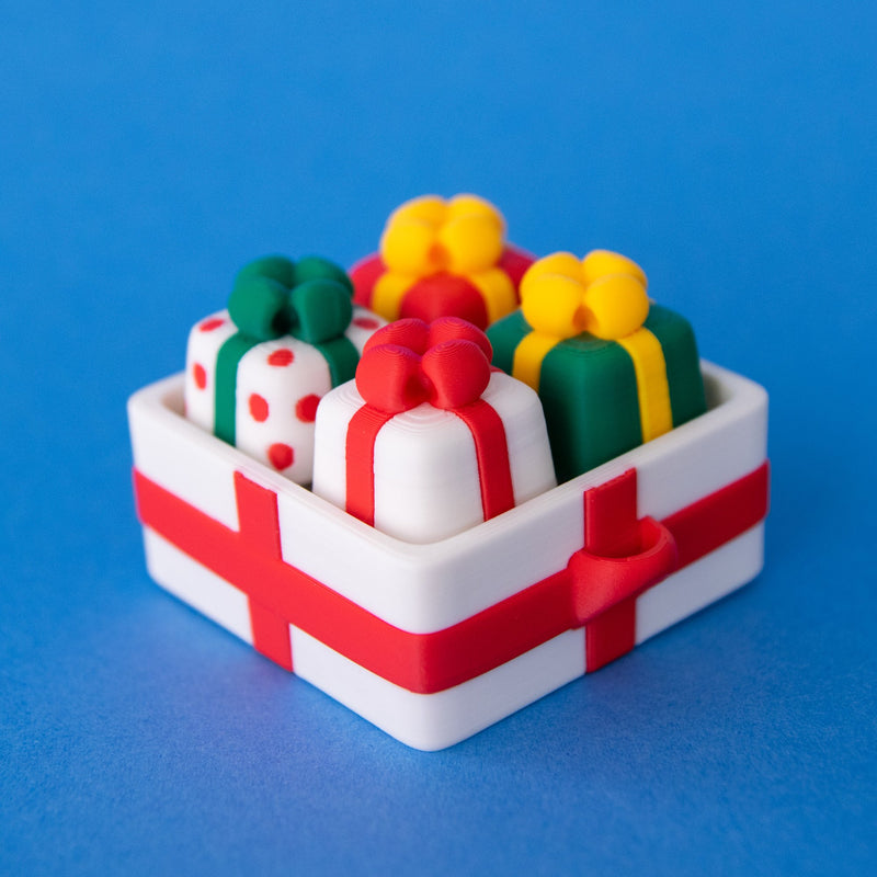 White four-slot gift box clicker base filled with four present keycaps