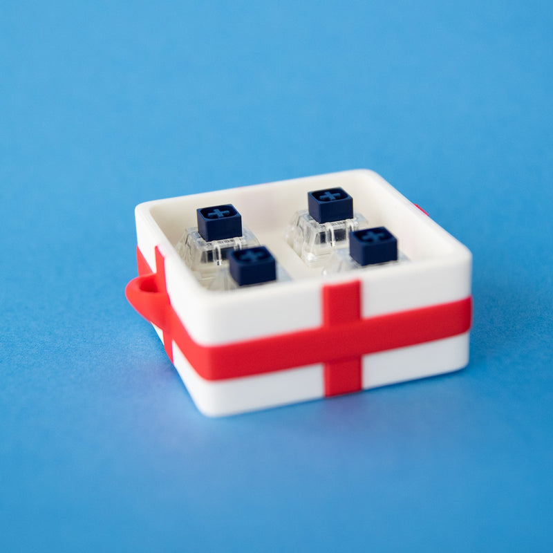 White four-slot gift box base with switches, seen from above