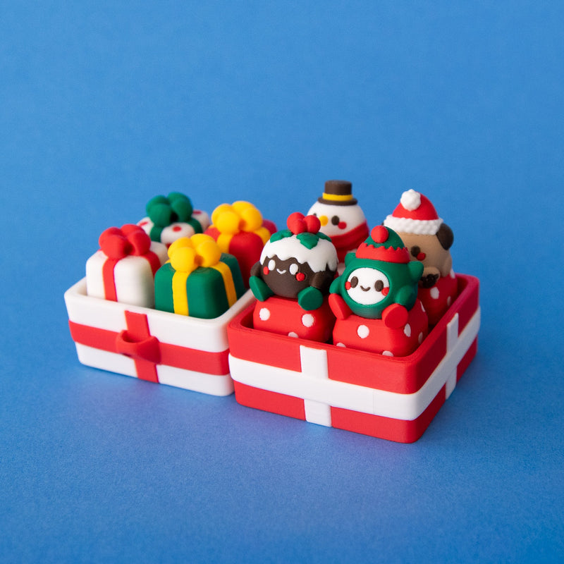Four-slot and two-slot gift box clicker bases side by side, filled with Christmas keycaps