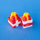 Red and white single gift box clicker bases, each holding a red present keycap with a yellow bow