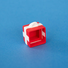 Empty red single gift box clicker base, angled view showing the keycap socket