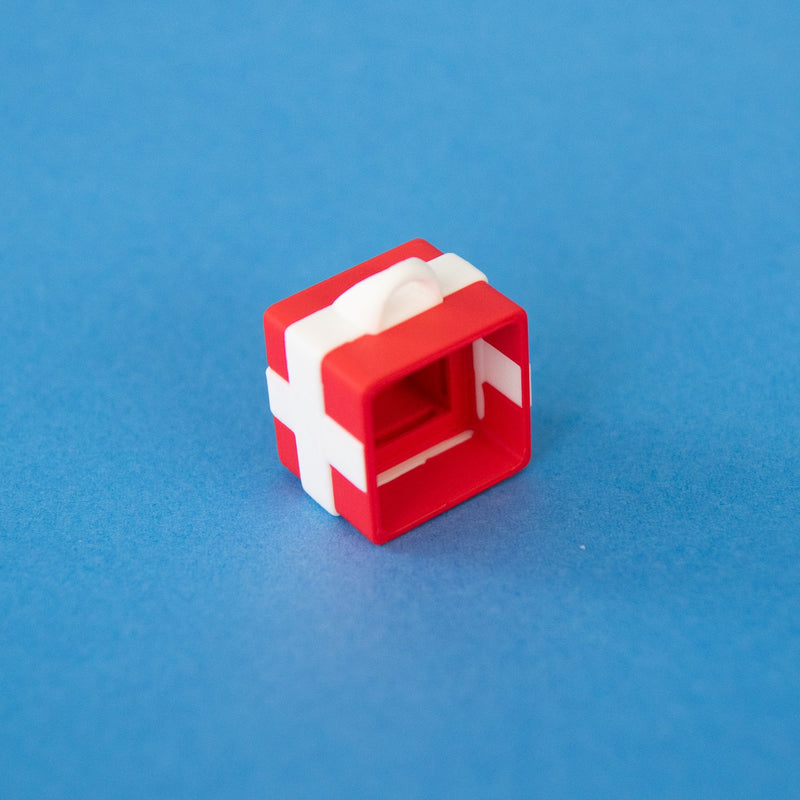 Red single gift box clicker base from the side, showing the ribbon loop