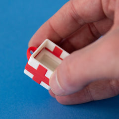 Empty white single gift box clicker base held in a hand
