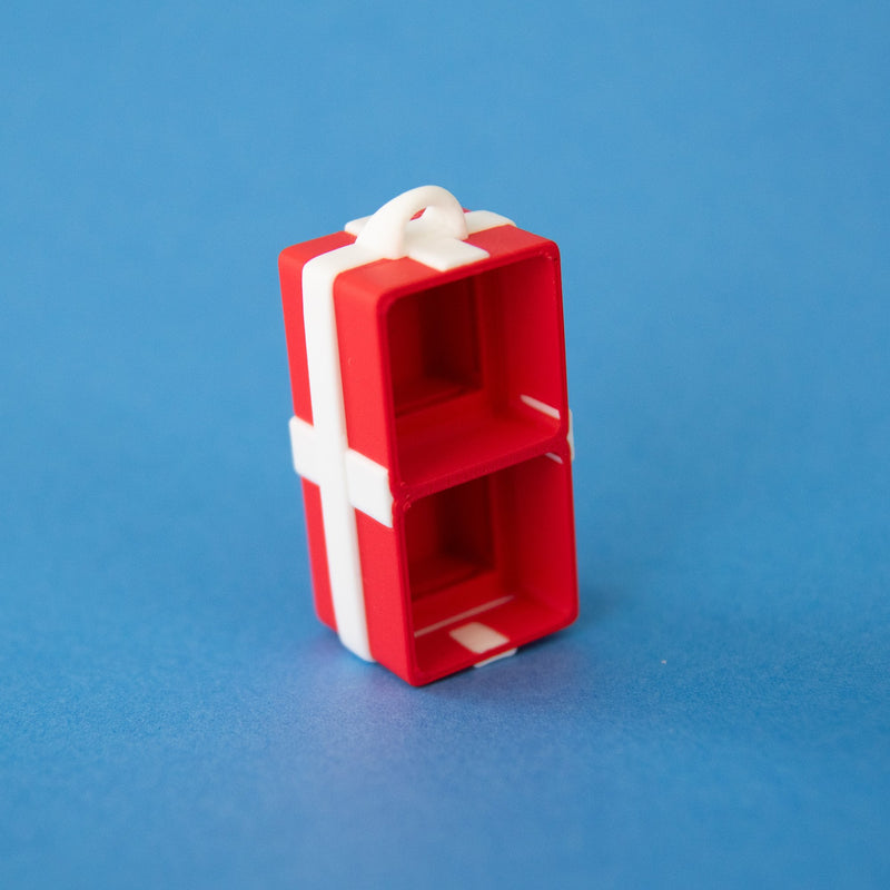 Empty red two-slot gift box clicker base, angled view