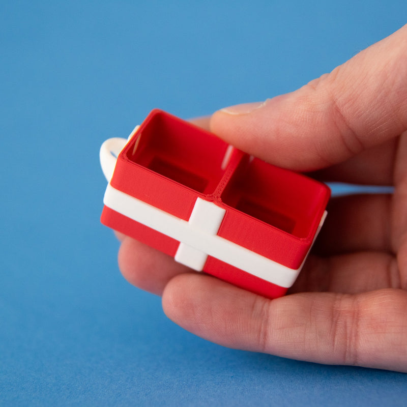 Empty red two-slot gift box base resting in a hand