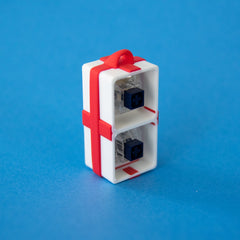 White two-slot gift box base with switches, upright from another angle