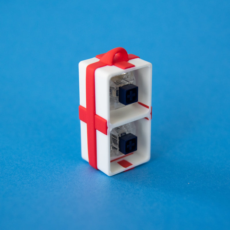 White two-slot gift box base with switches, upright from another angle