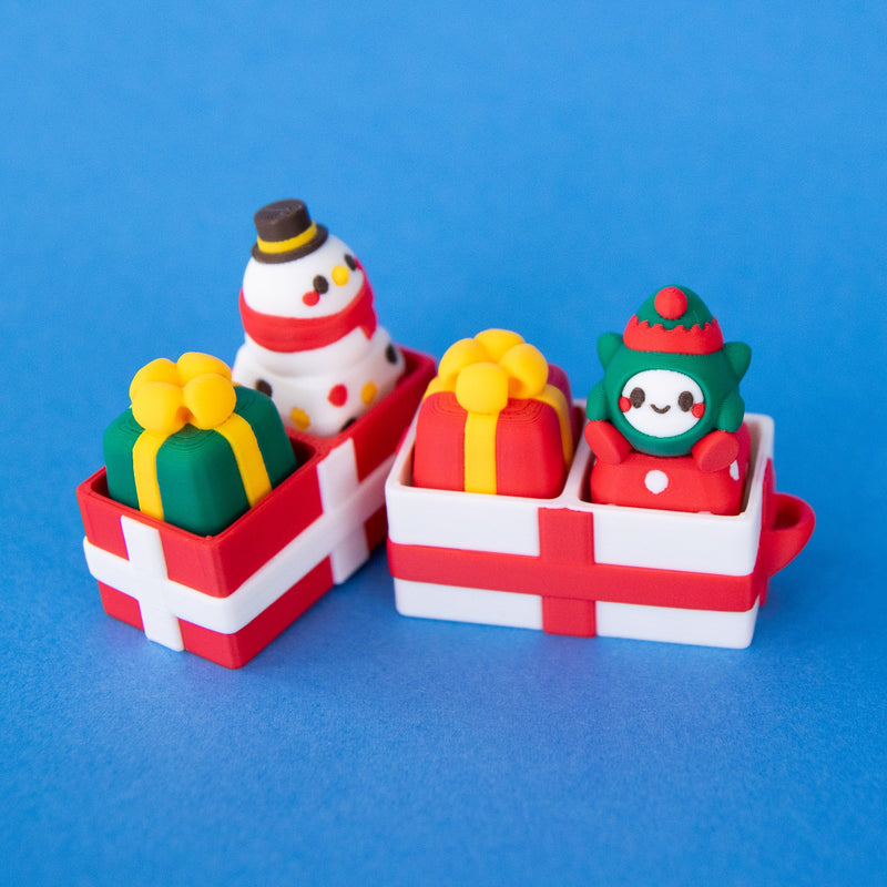 Two-slot gift box bases holding present, snowman and elf keycaps