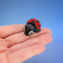 Close-up of Clover the ladybug fidget toy's face and spotted wings