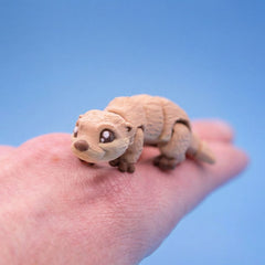 Tan river otter fidget toy walking across a hand
