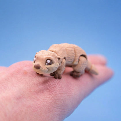 Tan river otter fidget toy walking across a hand