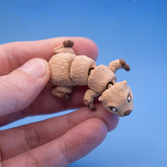 Close-up of Eddy the otter fidget toy's face and paws