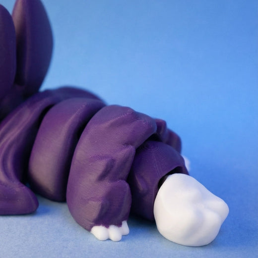 Close-up of the purple bat dragon's segmented body and white-tipped claws
