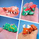 Four festive chonk dragon fidget toys shown together in a collage - a reindeer, an elf, and two others in holiday themes
