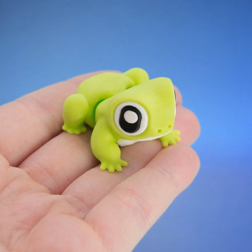 Close-up of Freddy the frog fidget toy's large eyes and white belly patch