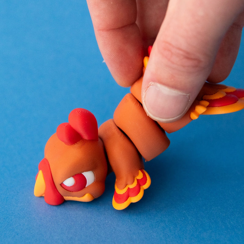 A hand lifting Gobb the Turkey Beastchonk to demonstrate his articulated body.