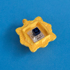 Gold frame keycap clicker with switch front view.