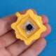 Gold frame keycap clicker with switch in hand view.