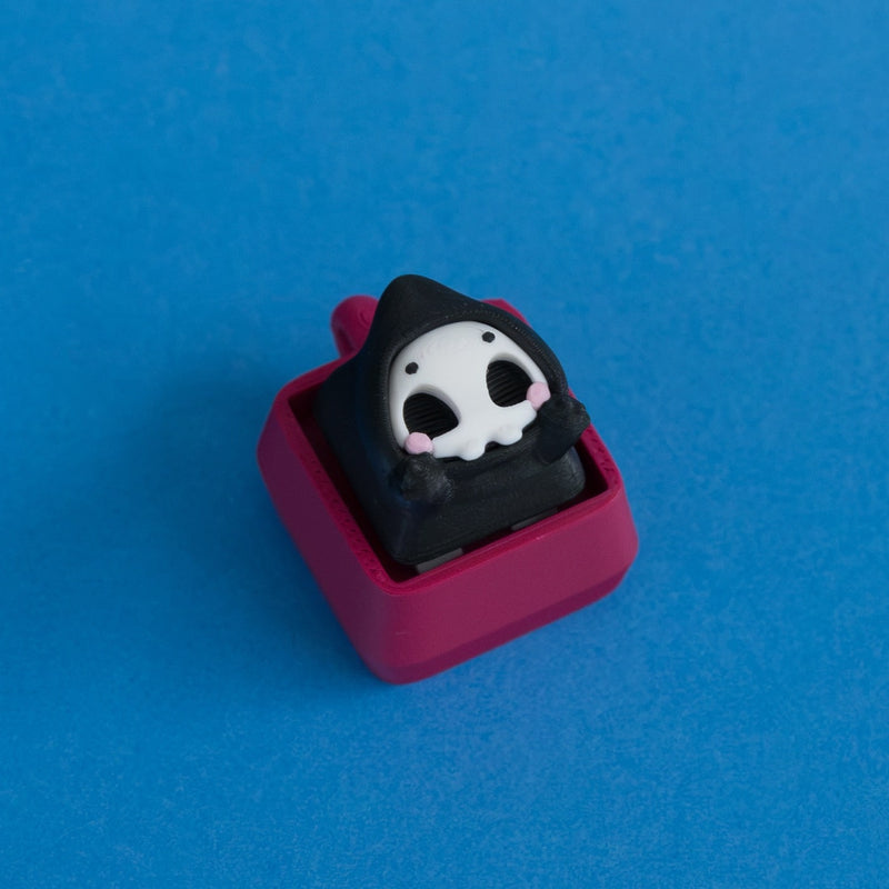 Grimsy the reaper keycap on plum clicker base.