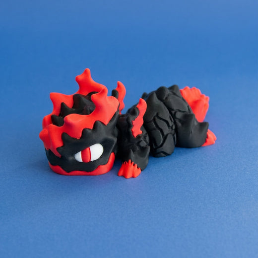 Opposite front view of Gritt the Lava Chonk showing the flame-shaped head details, feet and segmented body.