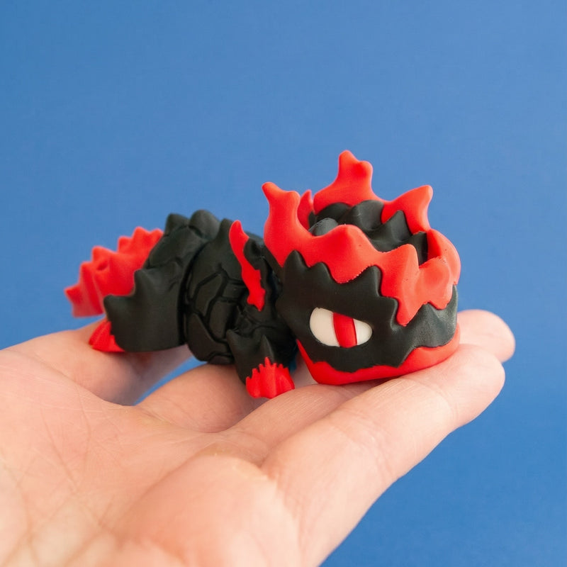 Gritt the Lava Chonk resting on an open palm to show his size.