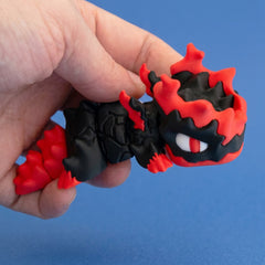 Gritt the Lava Chonk held by the body, showing the articulated segments and flame-shaped head details.