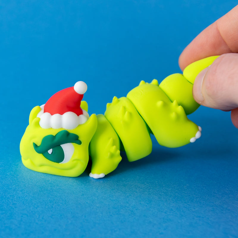 Fingers holding Grump's tail to show his articulated body