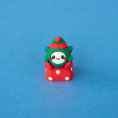 Jingle the elf keycap in a green and red elf hat, front view