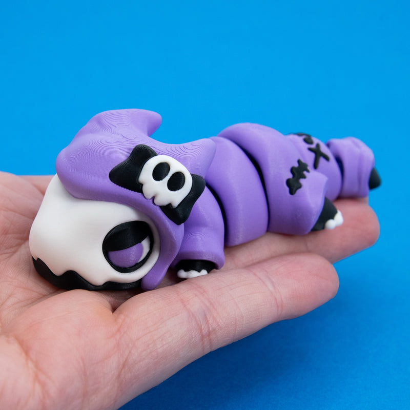 Kawaii Goth Reapo resting across an open palm