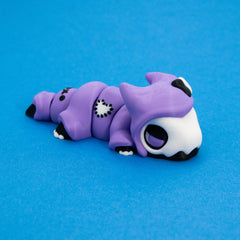 Kawaii Goth Reapo stretched out showing his articulated body and heart patch, left side view