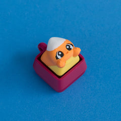 Kernie the candy corn keycap on plum clicker base.