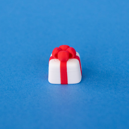 Mint the white present Christmas keycap, angled view