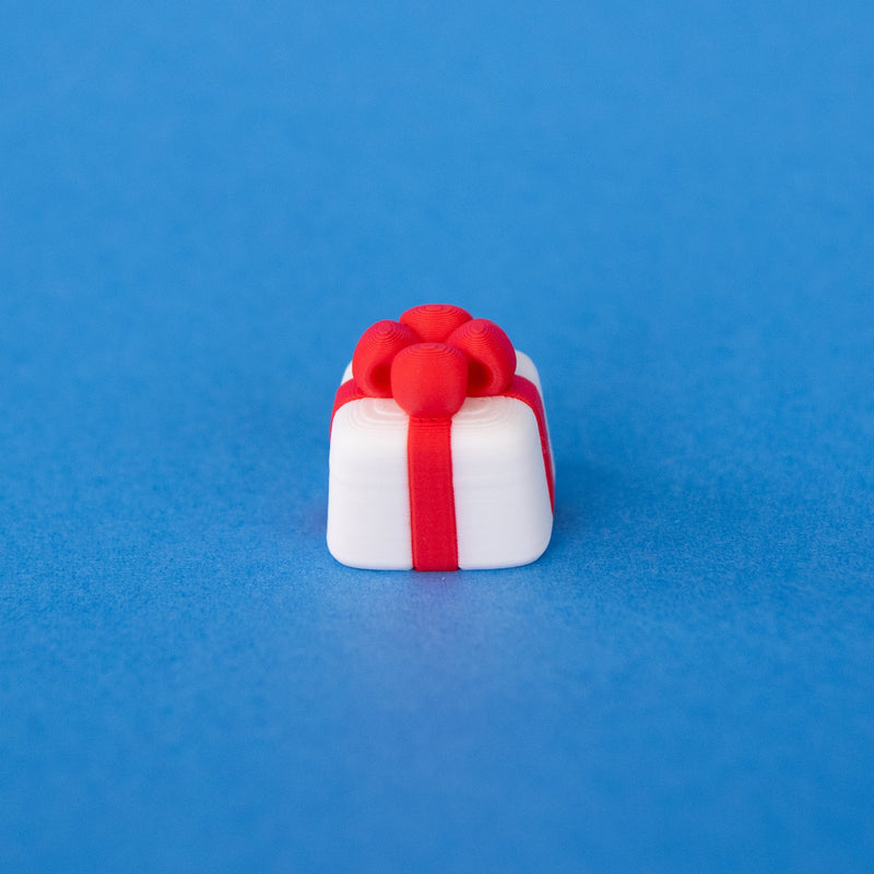 Mint the white present Christmas keycap, angled view