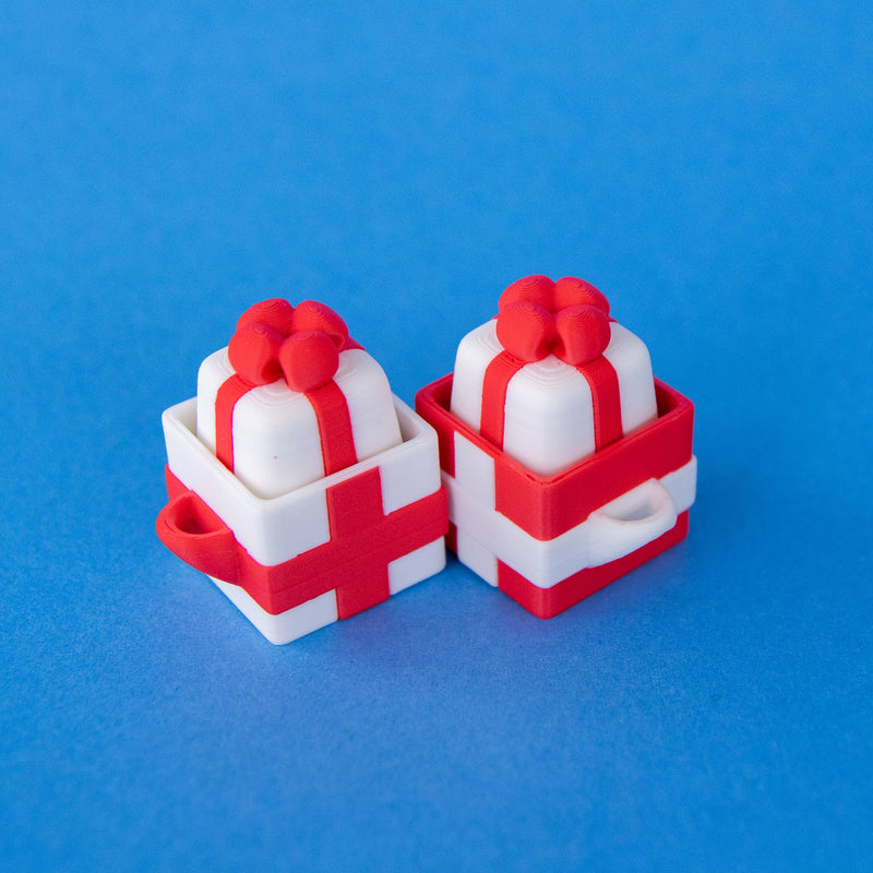 Mint white present keycaps sitting in red and white gift box clicker bases