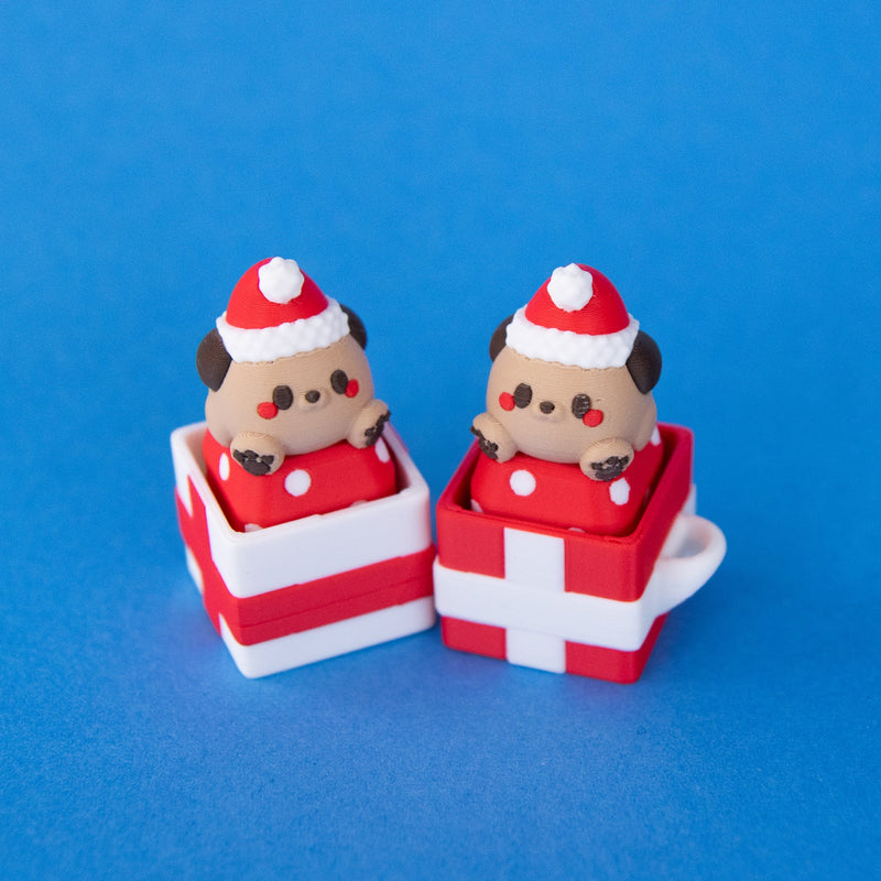 Nutmeg Santa puppy keycaps sitting in red and white gift box clicker bases