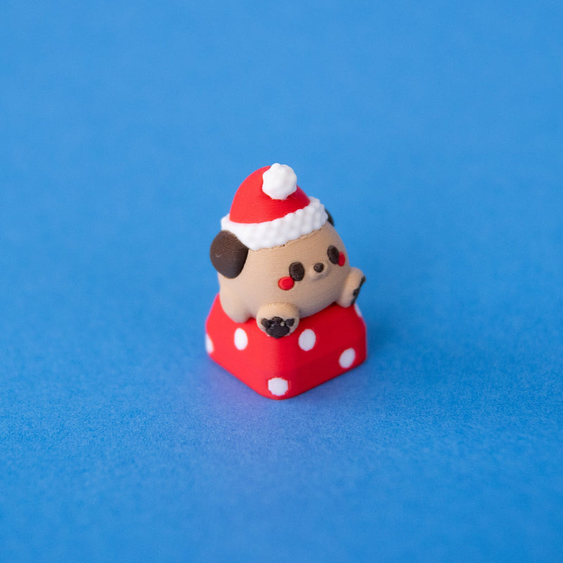 Nutmeg the Santa puppy keycap, three-quarter view from the right