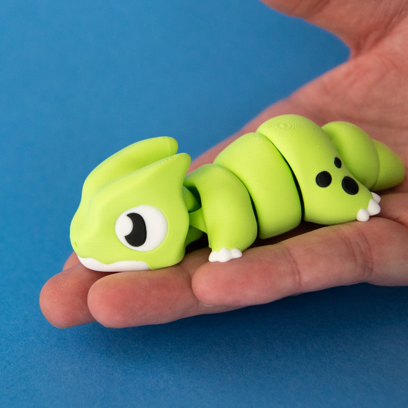 Orlo the Dino Beast Dragon resting in an open palm to show his size.