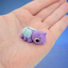 Purple pill bug fidget toy seen from behind, showing its segmented shell