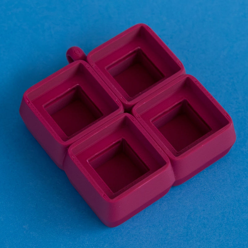 Plum four slot keycap clicker base empty front three quarter view.